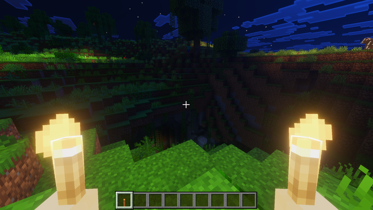 Player holding torch in offhand to illuminate surroundings